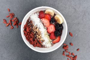 smoothie bowl with goji berries. Don't buy superfoods if you want to save money on groceries.