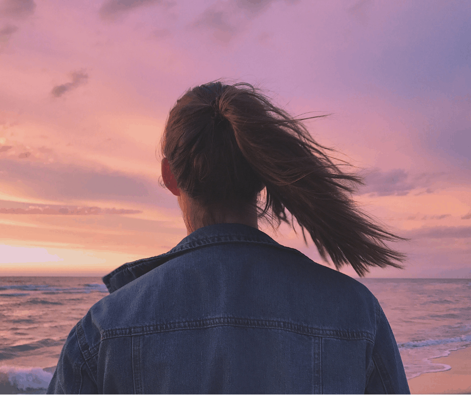 woman looking at sunset lives frugal life