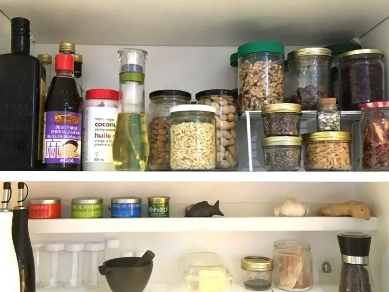 pantry shelves jars of oils, nuts, spices
