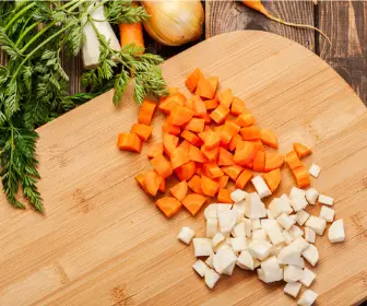 chopped carrot and potato on cutting board