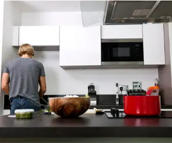 man cooking in clean kitchen