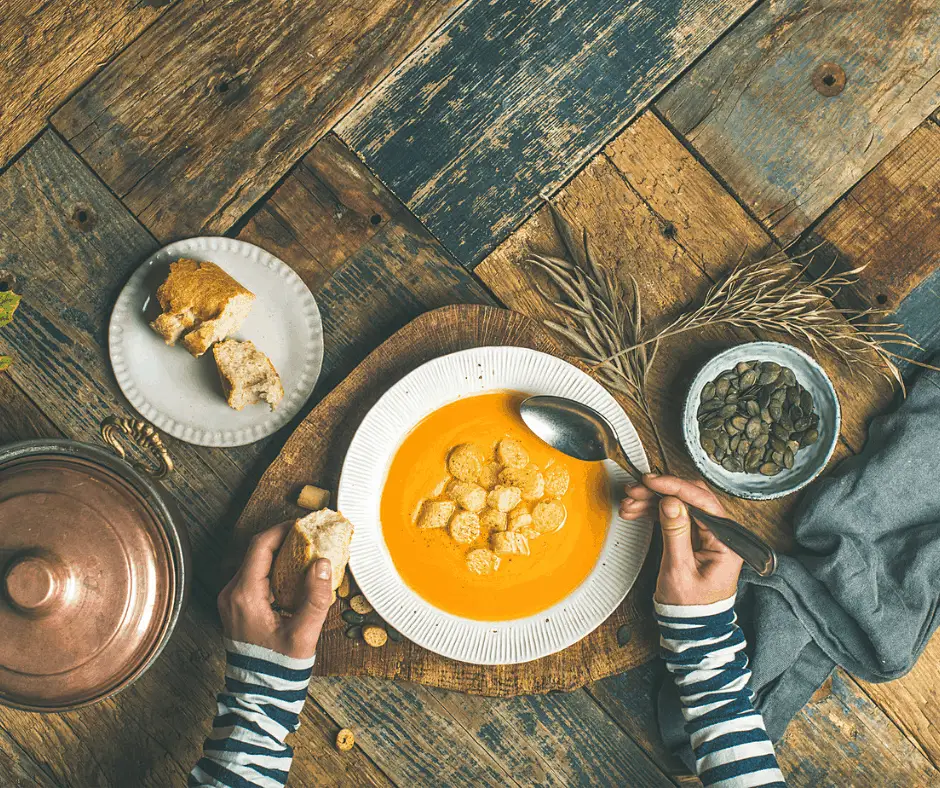 minimalist eating pumpkin soup and bread