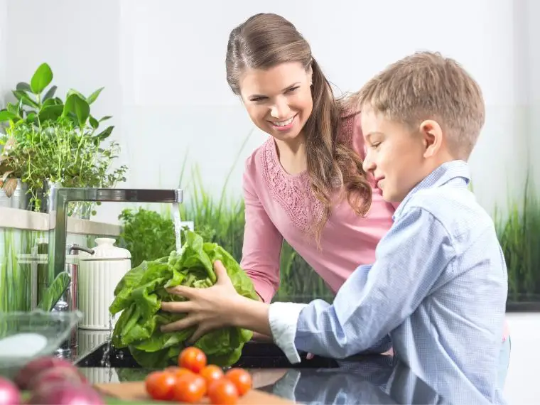 mom and son washing vegetables