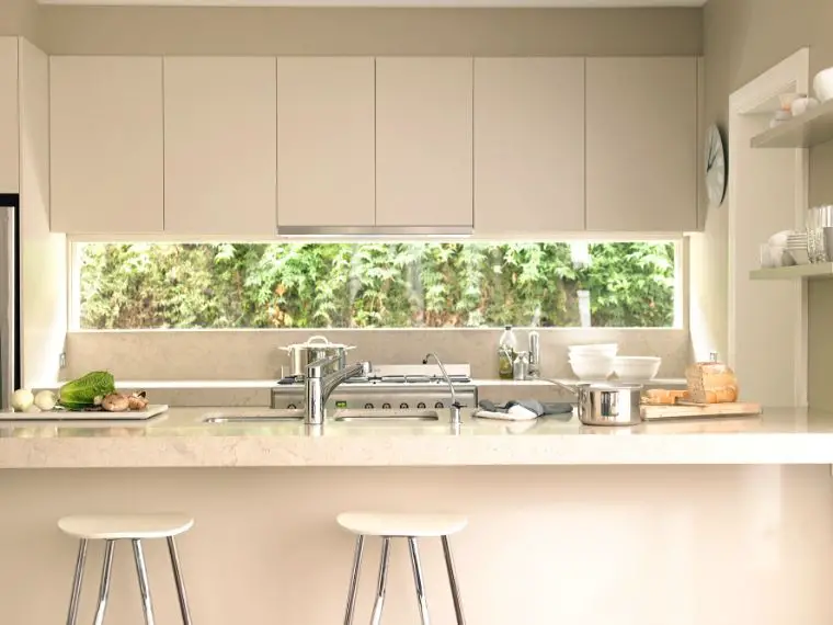 Minimalist kitchen white cupboards big window