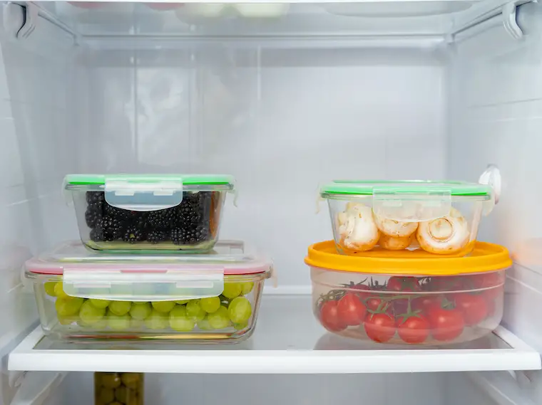 Meal prepping containers in clean & uncluttered fridge