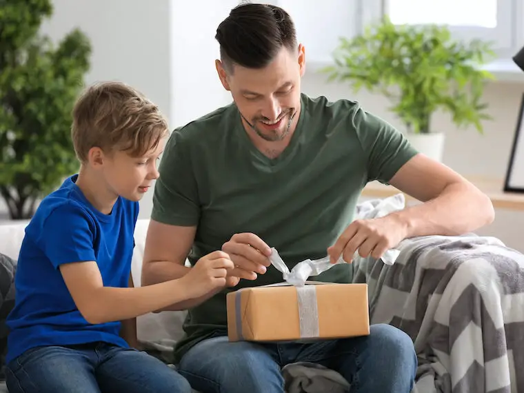man opening minimalist gift for him from son