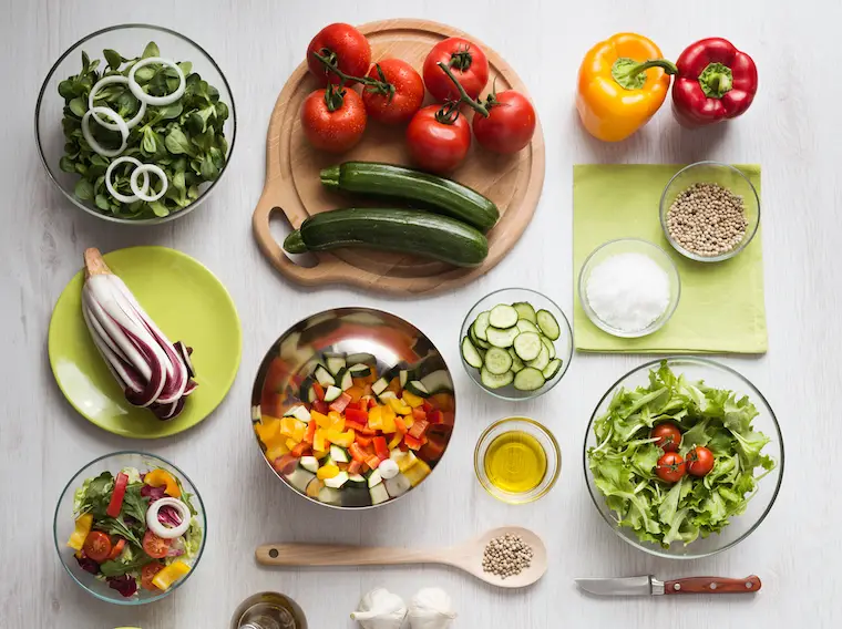 simple meal planning flatlay vegetables in bowls, on cutting boards