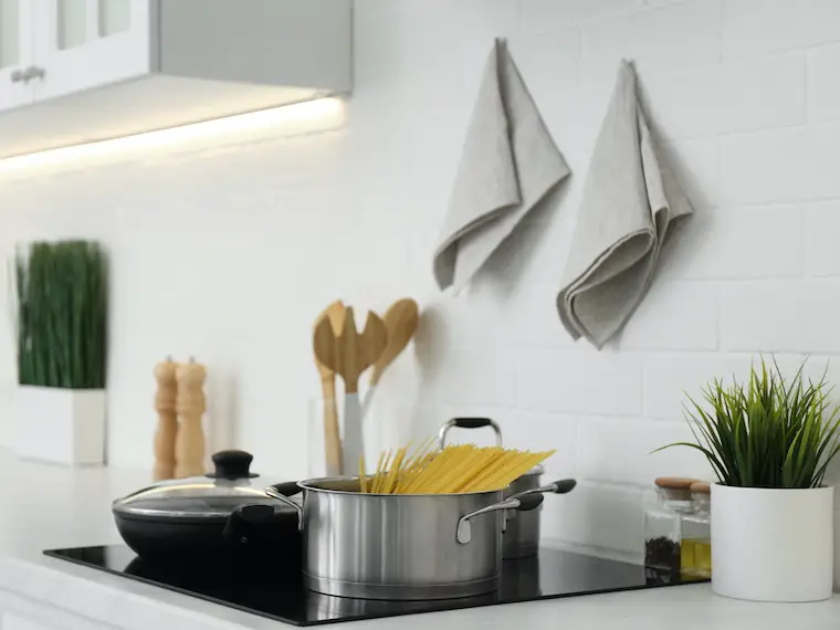 Amazon kitchen accessories Pot with uncooked pasta and frying pan on stove in kitchen